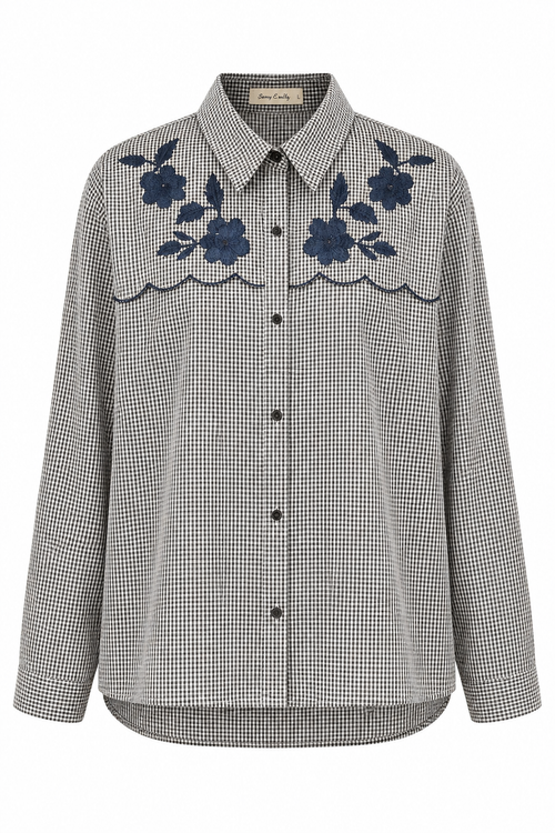 A long-sleeve button-up shirt in a gray and white micro-check pattern, featuring dark blue floral embroidery and scalloped trim across the chest, shown against a plain white background.